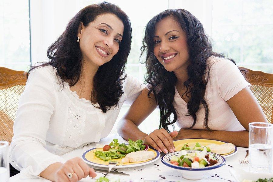 Middle Eastern Women Sit at a Table Eating Food