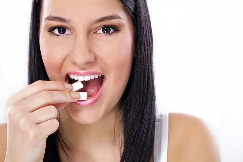 Smiling woman with gum and breath mints